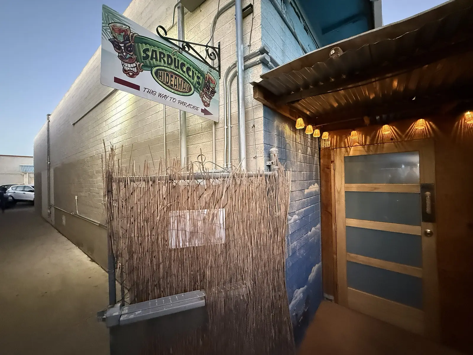The Hideaway door lit up at dusk